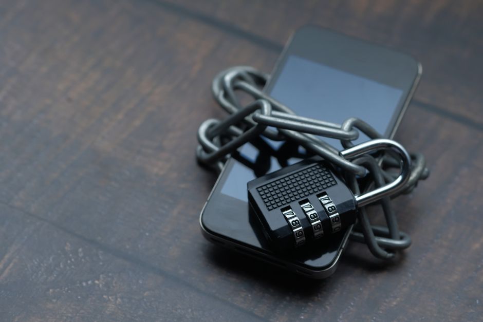A padlock over a smartphone, representing app security and privacy
